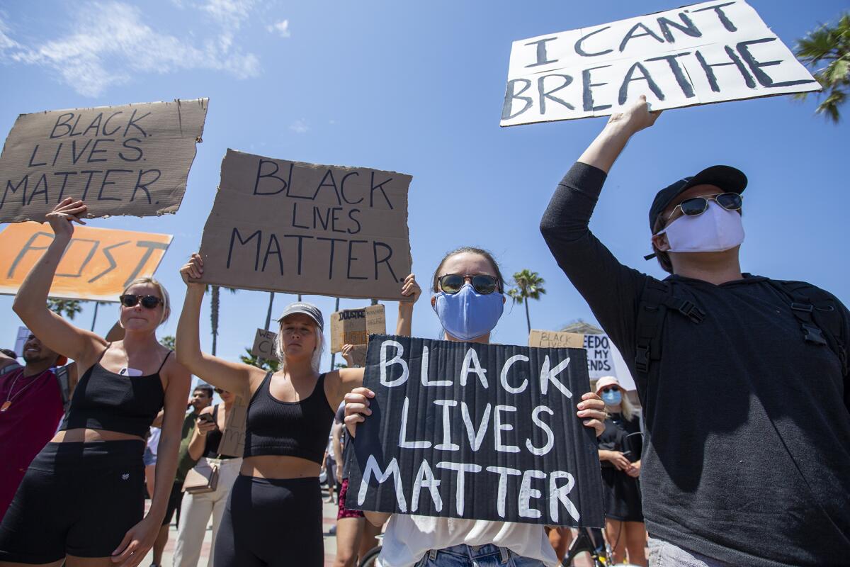 Demonstrators protesting George Floyd's death and supporting the Black Lives Matter movement participate peacefully.