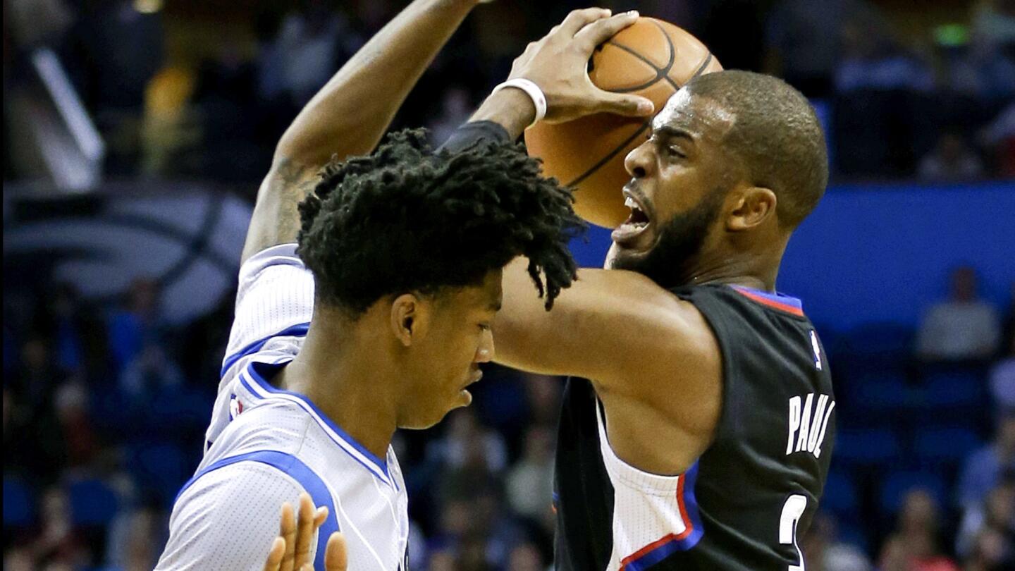 Clippers point guard Chris Paul draws a foul from Magic guard Elfrid Payton while attempting a shot during their game Friday night in Orlando.