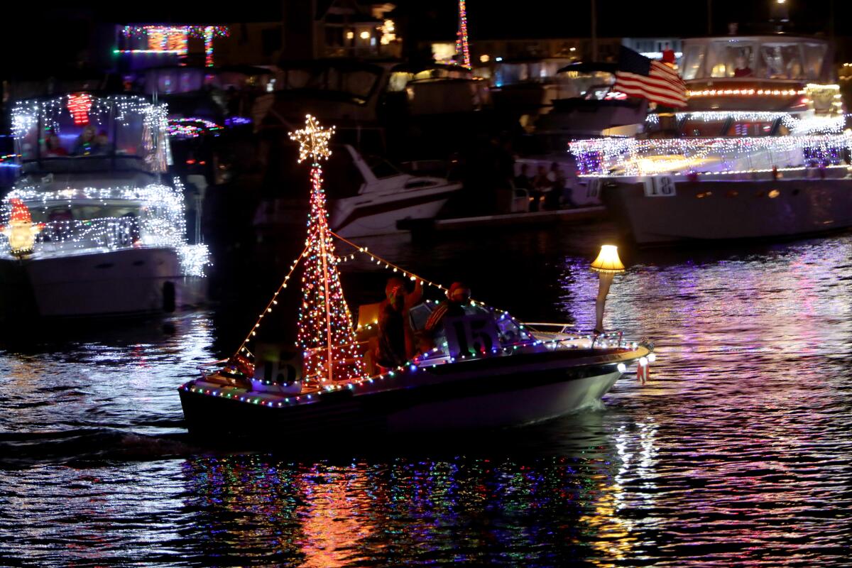 Lights decorate boats for a holiday parade.