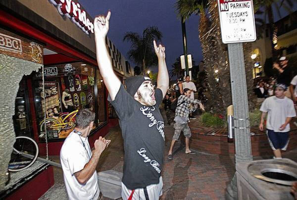 This photo of a man outside a damaged bike shop in Huntington Beach on Sunday night went viral.