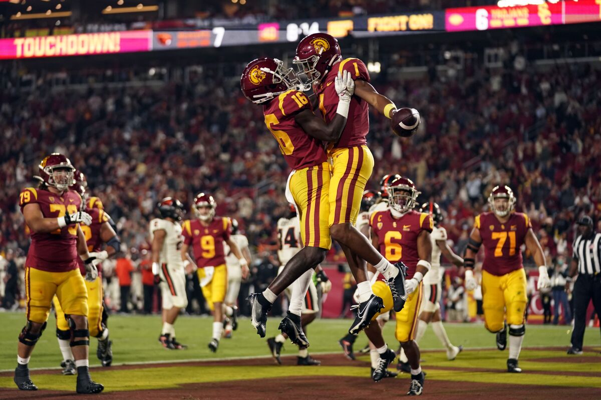 Southern California wide receiver Gary Bryant Jr. celebrates his touchdown catch with wide receiver Tahj Washington.