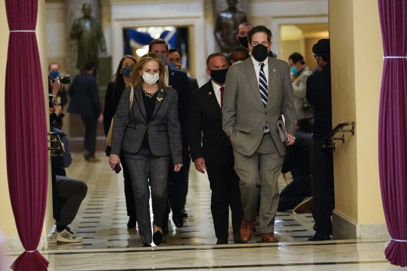 Impeachment managers Rep. Madeleine Dean, D-Pa., and Rep. Jamie Raskin, D-Md., walk to the House chamber on Capitol Hill in Washington, Wednesday, Jan. 13, 2021. (AP Photo/Susan Walsh)