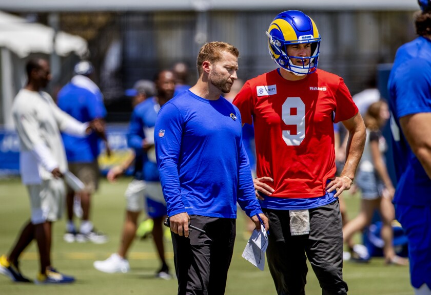 Rams coach Sean McVeigh talks to quarterback Matthew Stafford at training camp on Sunday.