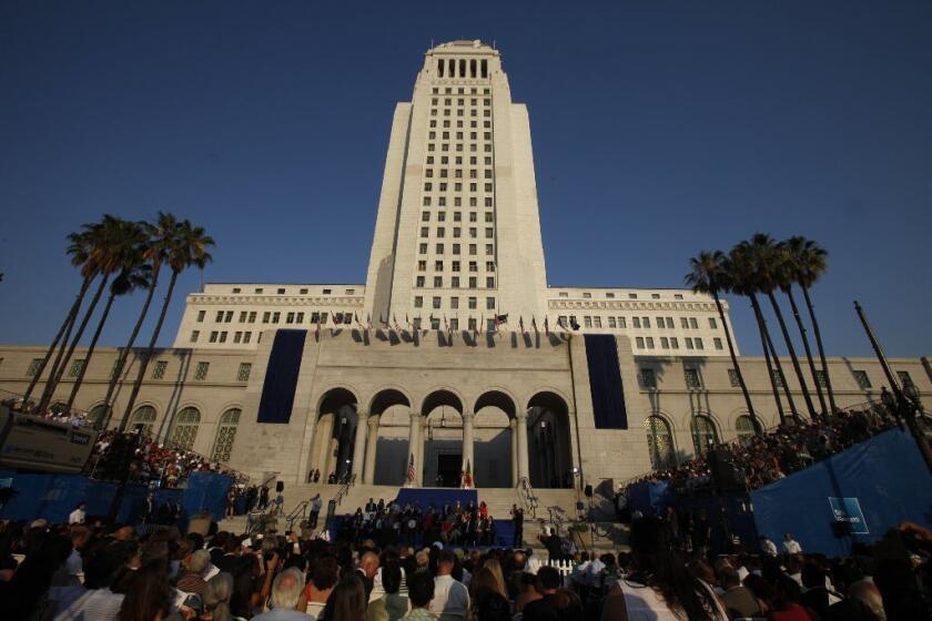 Los Angeles' public employee pension funds have had to recalculate how much they will earn in the years ahead. Above, Los Angeles City Hall on Mayor Eric Garcetti's inauguration day in June 2013.