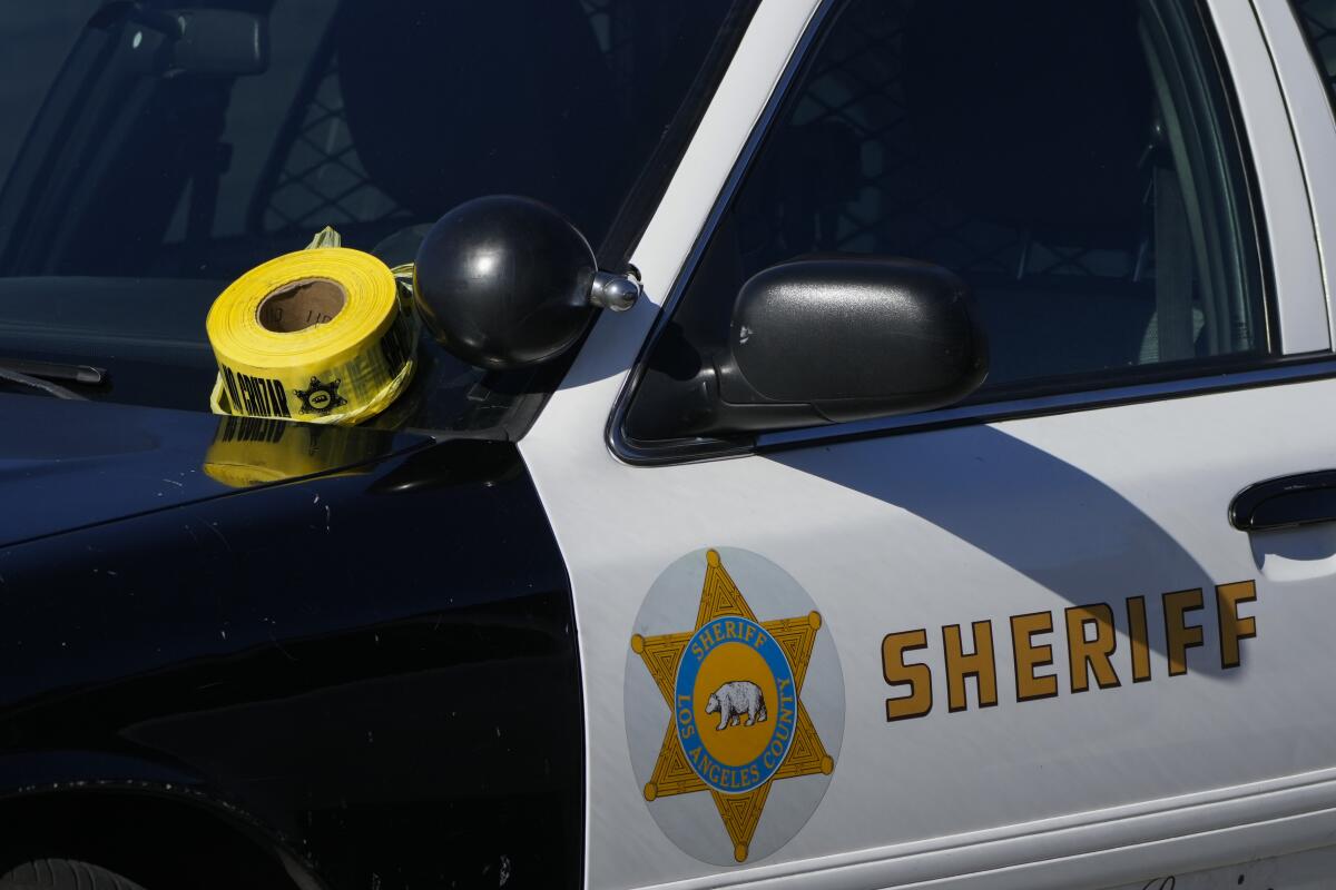 A roll of police tape is left on the windshield of Los Angeles County sheriff's vehicle