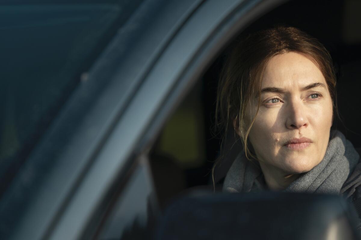 Kate Winslet looks out of a car window.