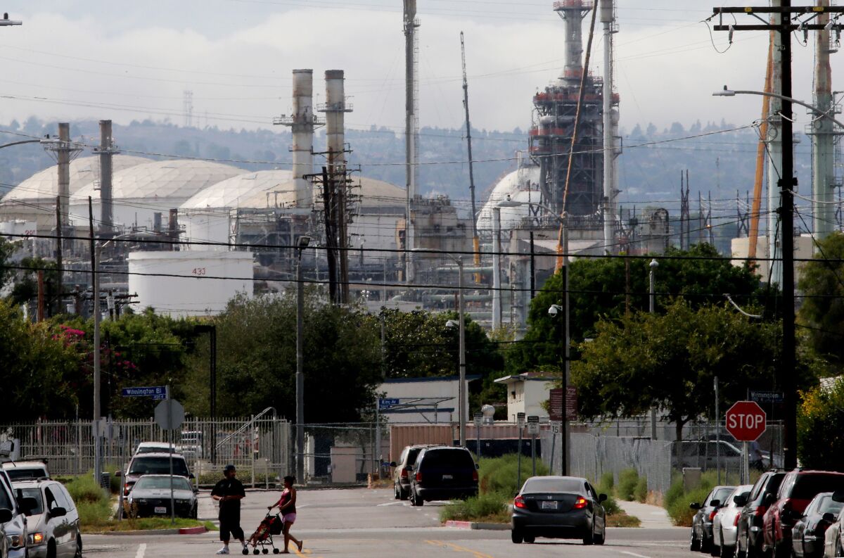 A refinery complex sits adjacent to a neighborhood in Wilmington. (Luis Sinco / Los Angeles Times)