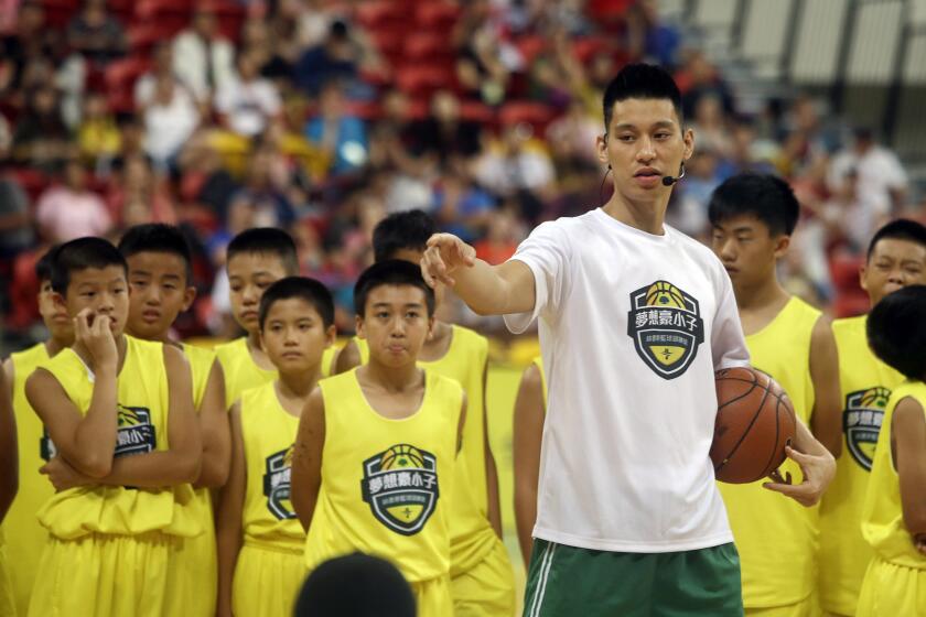 NBA free agent Jeremy Lin, talks to young basketball players Saturday during a clinic in Taipei, Taiwan. (AP Photo/)