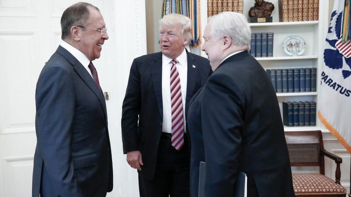 A handout photo made available by the Russian Foreign Ministry shows President Trump speaking with the Russian foreign minister and the Russian ambassador to the U.S. at the White House on Wednesday.