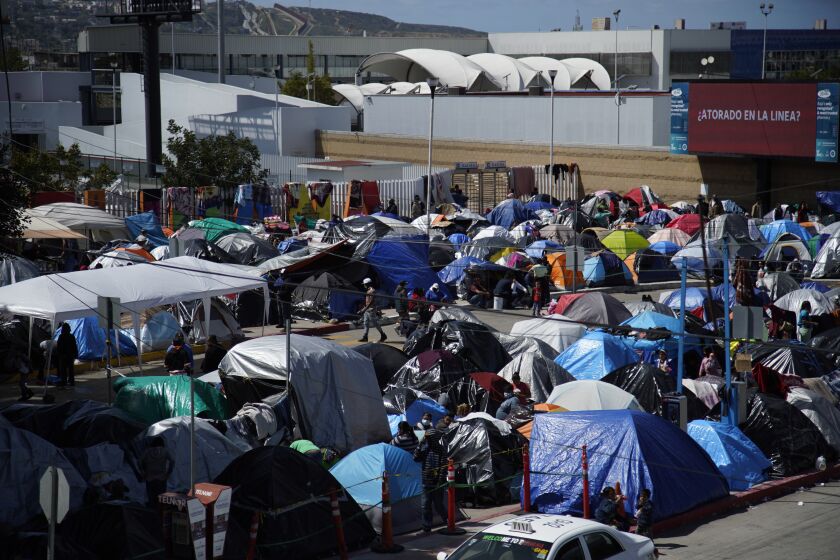 Tijuana, Baja California - March 16: Hundreds of asylum seekers camp out at Tijuana right by the port of entry at the Chaparral plaza. at Chaparral Border Crossing on Tuesday, March 16, 2021 in Tijuana, Baja California (Alejandro Tamayo / The San Diego Union-Tribune)