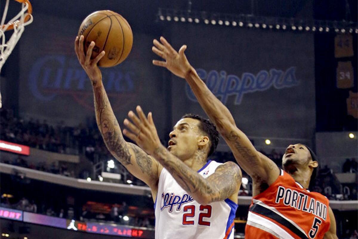 Matt Barnes shoots as Will Barton defends during the first half of the Clippers matchup with the Portland Trail Blazers on Tuesday.