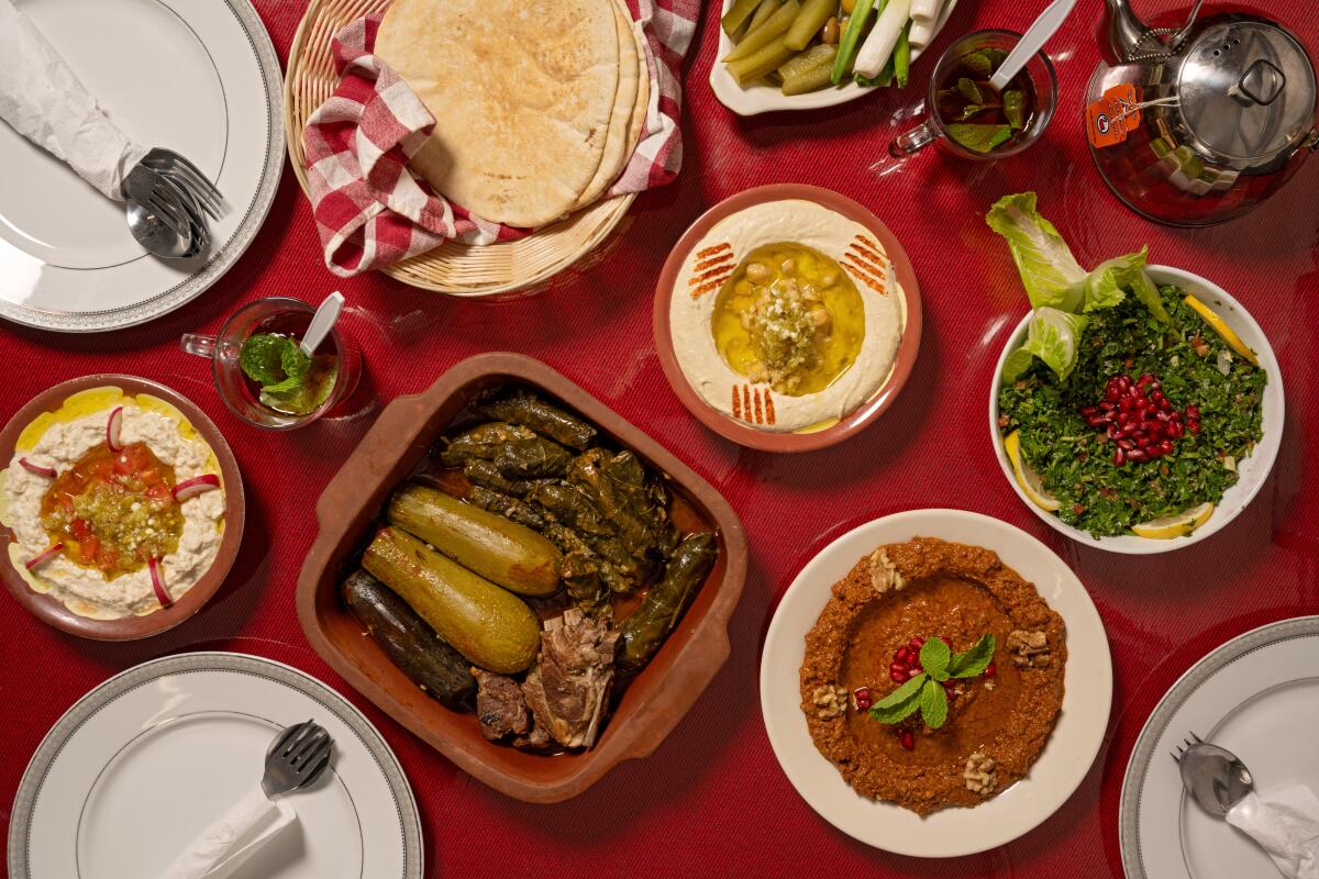 ANAHEIM, CA - OCTOBER 22, 2024: Spread of dishes including the Tuesday special: Kusa & Grape Leaves with Meat along with popular sides like hummus, muhamara, baba ghanouj, and tabbouli at Al Baraka in Anaheim (Ron De Angelis / For The Times)