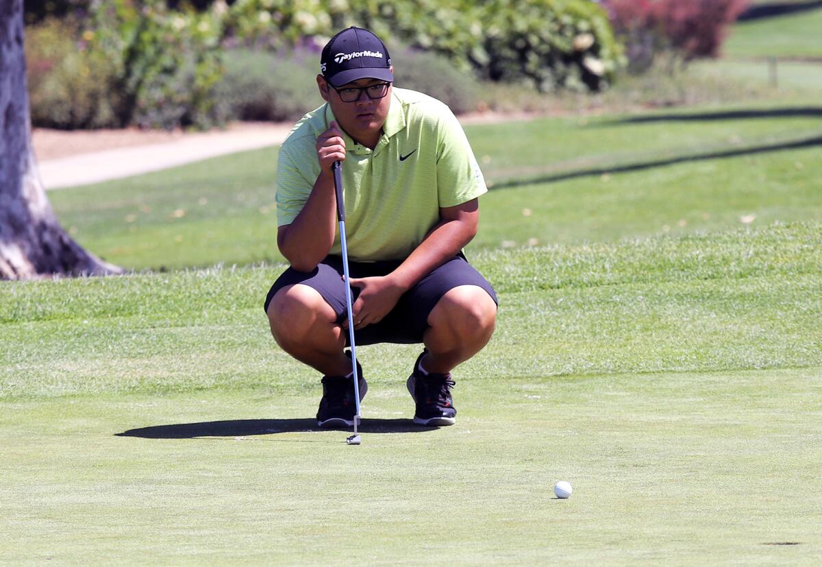 Edison's Timothy Jung reads a putt during the CIF State boys' golf championship at the San Gabriel Country Club.