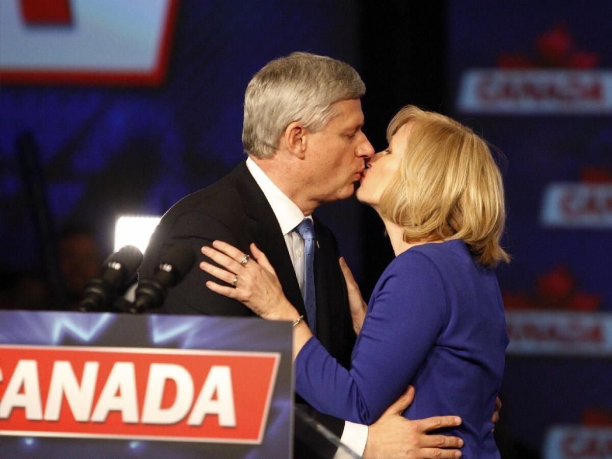 Stephen Harper and his wife, Laureen, smooch before the prime minister addresses supporters on election night. He will be replaced by 43-year-old Justin Trudeau of the Liberal Party.