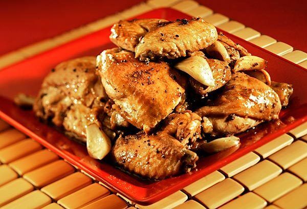 In this take on chicken adobo from chef Andre Guerrero, chicken pieces are simmered in a fragrant blend of soy sauce, garlic, cider vinegar, black pepper and bay leaves. When the chicken is tender, the sauce is reduced, then tossed again with the chicken before serving. It's a wonderfully rich yet simple dish, perfect served alongside a simple salad or side -- Guerrero recommends jasmine rice -- and it comes together in only an hour.