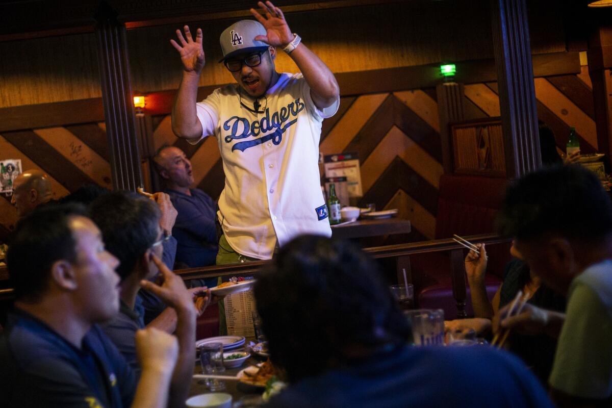 OB Bear manager Joon Park talks to guests. (Kent Nishimura / Los Angeles Times)