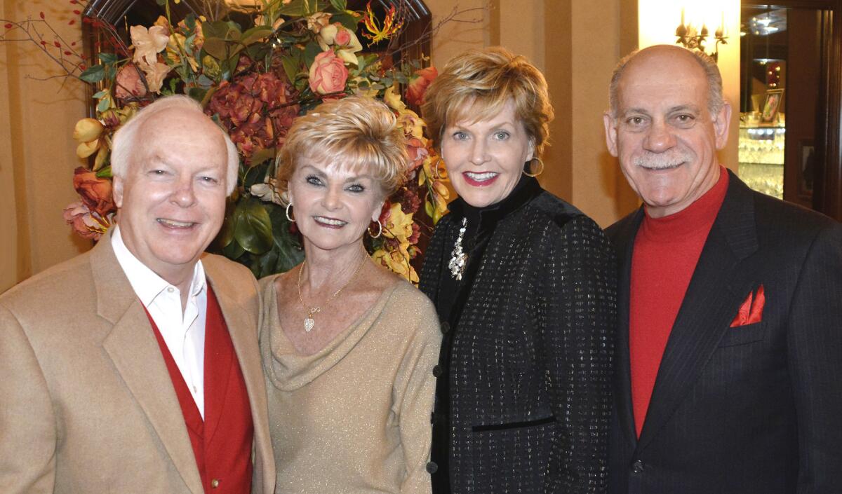 Former Burbank Mayor Bob Bowne and his wife Dianne, left, and Vic and Sue Georgino, arrive at the home of Chuck and Tracy Cusumano for last week's holiday gathering.