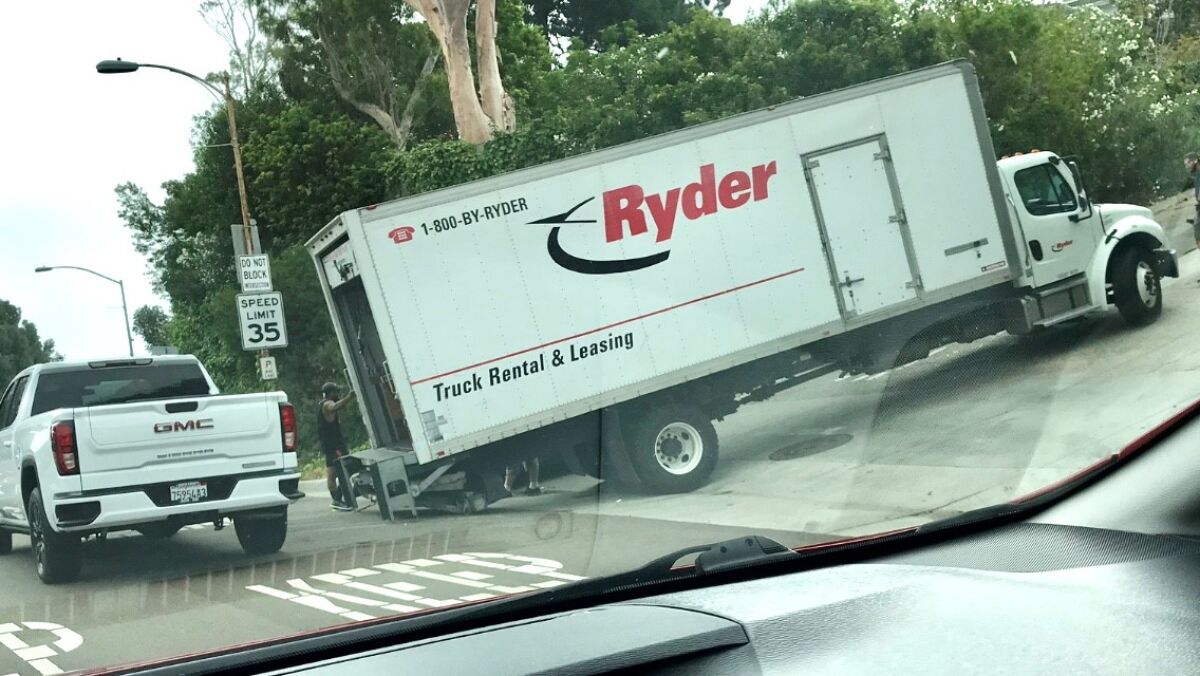 A truck gets stuck heading up Hillside Drive in La Jolla from Torrey Pines Road in July.