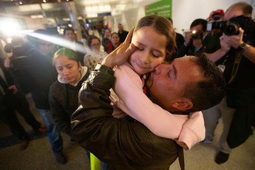 Los Angeles, CA., January 22, 2020 — Fernando Arredondo embraces his daughter, Alison Arredondo, at LAX on Wednesday, January 22, 2020 in Los Angeles, California. Arredondo was one of 11 parents who were deported without their children during the zero tolerance policy. Nine of the parents returned to the U.S. on Wednesday and were reunited with their families. (Jason Armond / Los Angeles Times)