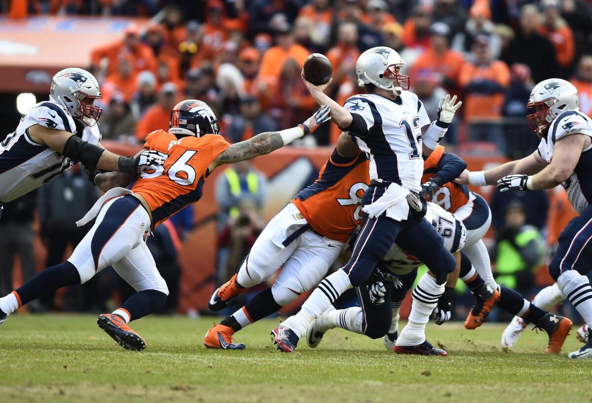 Broncos linebacker Shane Ray reaches for Patriots quarterback Tom Brady as he attempts to pass during the second half of the AFC championship game.