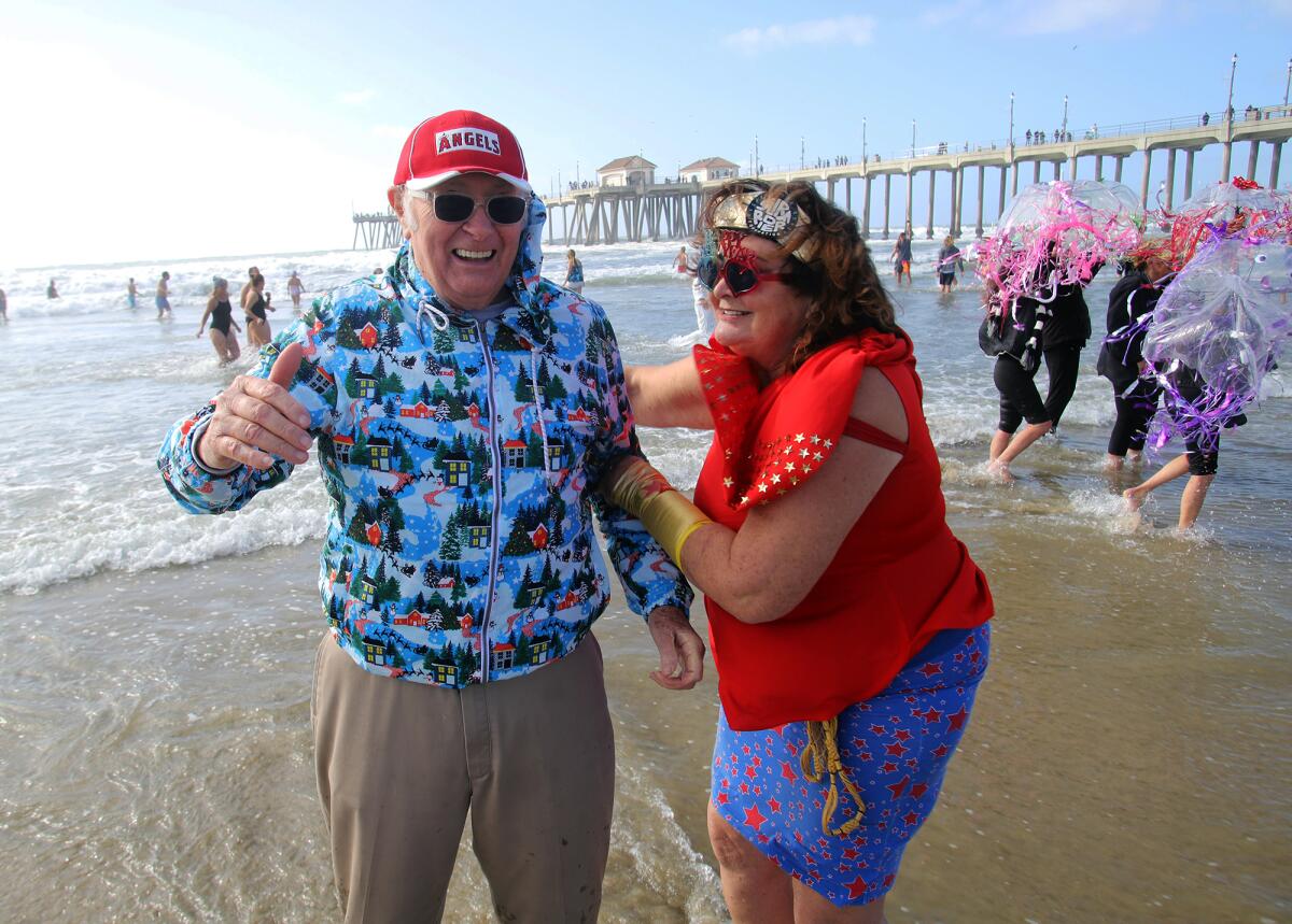 Jack Carey, 89, of Huntington Beach, and Lee Love Ghione during the Surf City Splash on Jan. 1, 2023.