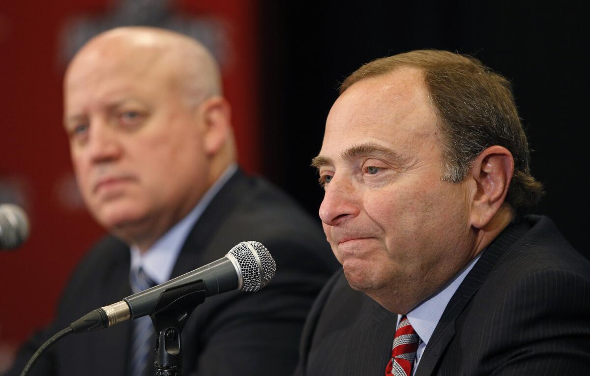 NHL Commissioner Gary Bettman, right, speaks at a news conference before the NHL Awards show in June. At left is Deputy Commissioner Bill Daly.