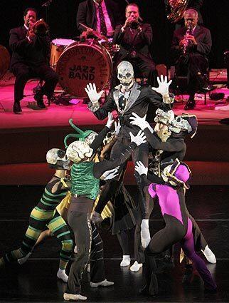 The dancers of the Trey McIntyre Project shared the jubilant spirit of the Preservation Hall Jazz Band at Walt Disney Concert Hall on Nov. 22. Here, the mask-wearing dancers play for macabre humor.