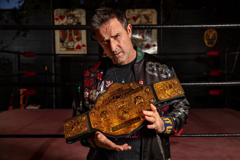 ENCINO, CA --MARCH 07, 2020 -Actor David Arquette is photographed holding his championship belt won from his April26,2000, \WCW World Heavyweight Championship, done during promotion of his film, "Ready to Rumble," along with his backyard wrestling ring, in advance of a screening of, "You Cannot Kill David Arquette," at Arquette's Encino, CA, home, March 07, 2020. The documentary following Arquette's foray into professional wrestling, was set to premier at the SXSW festival, but after it was cancelled due to the COVID-19 virus, Arquette's wife Christina McLarty Arquette, an executive producer of the doc, decided to host a screening of the film at their home. (Jay L. Clendenin / Los Angeles Times)