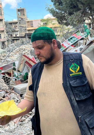 Abbass Salloum stands amid the rubble of a municipal building in Nabatieh after se