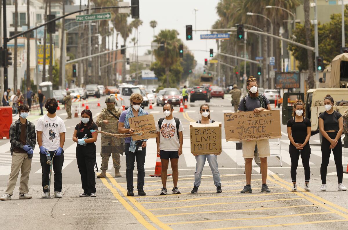 Black Lives Matter protesters stand in the middle of Ocean Avenue at Colorado in Santa Monica on June 1.