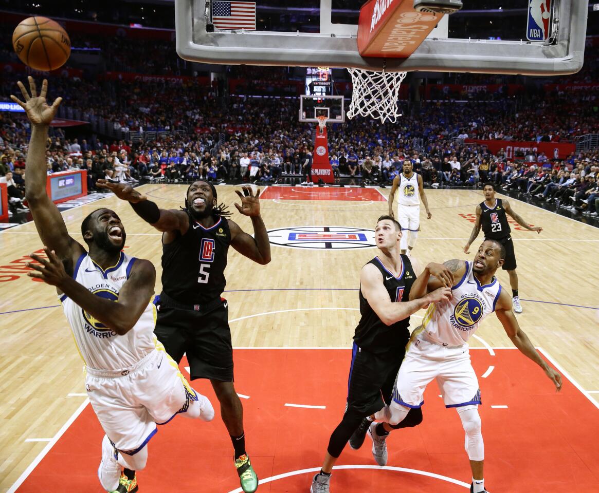 Warriors' Draymond Green struggles to shoot over Clippers' Montrezl Harrell during the second half.