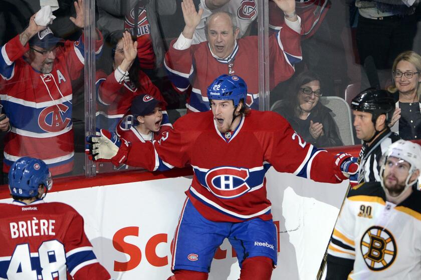 Montreal Canadiens forward Dale Weise, center, celebrates with teammate Daniel Briere, left, as Boston Bruins defenseman Andrej Meszaros skates past after scoring during the second period of the Canadiens' 4-2 playoff win Tuesday.