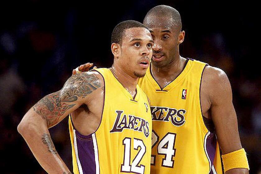 Lakers guard Kobe Bryant confers with teammate Shannon Brown in the fourth quarter Wednesday night.