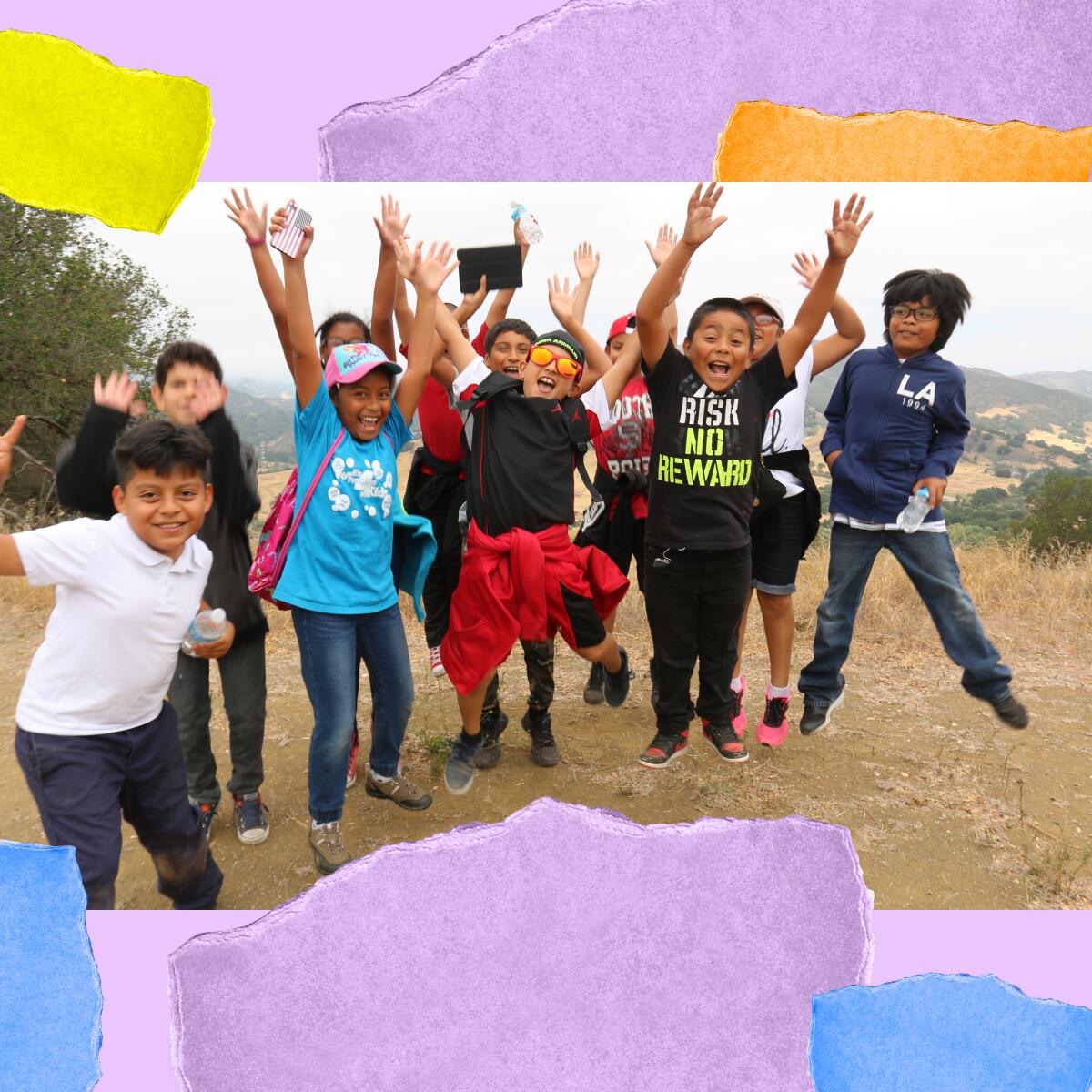 Kids on a hike jump with the arms raised.