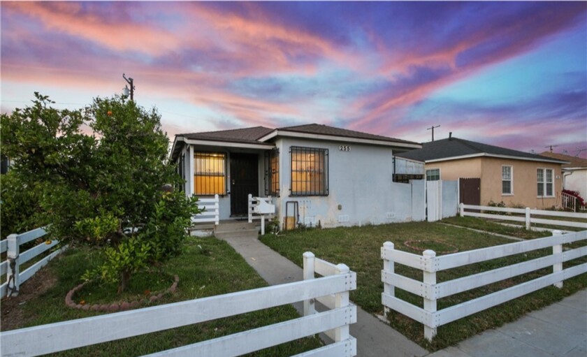 This home includes a white-fenced frontyard.