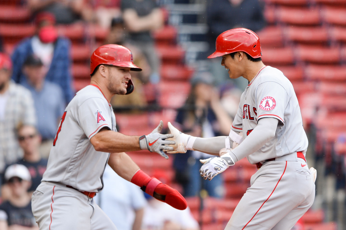 Shohei Ohtani, right, celebrates with Angels teammate Mike Trout after hitting a two-run home run.