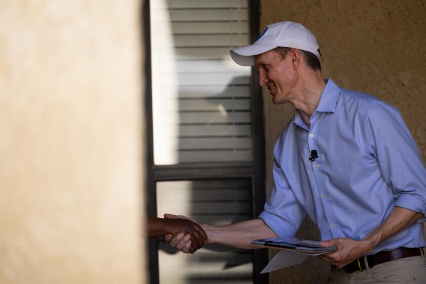 Lancaster, CA - July 27: George Whitesides shakes hands with Tanya King, 64, at her front door in Lancaster, CA on Saturday, July 27, 2024. (Zoe Cranfill / Los Angeles Times)