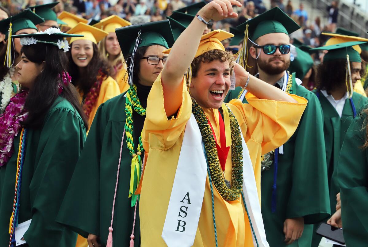 Edison High graduate Tyler Amelotte yells out to his family during the Chargers' commencement ceremony on Wednesday.