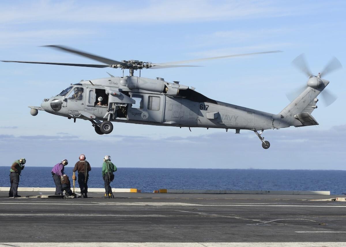 FILE - In this March 19, 2017, file photo, released by the U.S. Navy, an MH-60S Sea Hawk helicopter prepares to land on the flight deck of the aircraft carrier USS Nimitz in the Pacific Ocean. The remains of five people and the wreckage of a U.S. Navy helicopter that crashed in the Pacific Ocean off California have been recovered, the Navy said in a statement Tuesday, Oct. 12, 2021. An MH-60S helicopter, similar to the one pictured, its two pilots and three other sailors were lost in an Aug. 31 accident about 69 miles (111 kilometers) off the San Diego coast. (Mass Communication Specialist Seaman Ian Kinkead/U.S. Navy via AP, File)