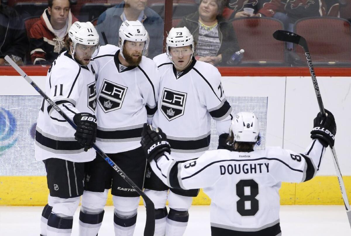 Jake Muzzin, second from the left, celebrates with Anze Kopitar (11), Tyler Toffoli (73) and Drew Doughty (8) after scoring on the Coyotes during the second period of a game on Feb. 2.