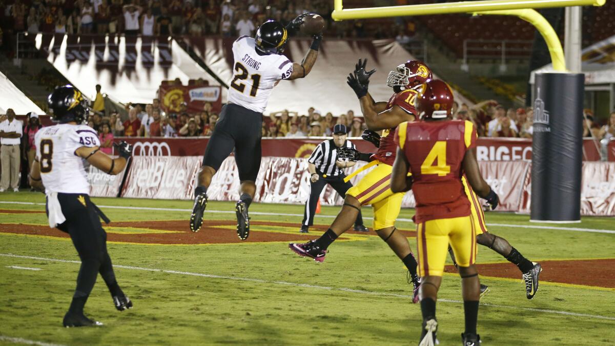 Arizona State's Jaelen Strong, center, catches a 49-yard pass to score a touchdown on the final play of the Sun Devils' 38-34 comeback win over USC at the Coliseum on Oct. 4.