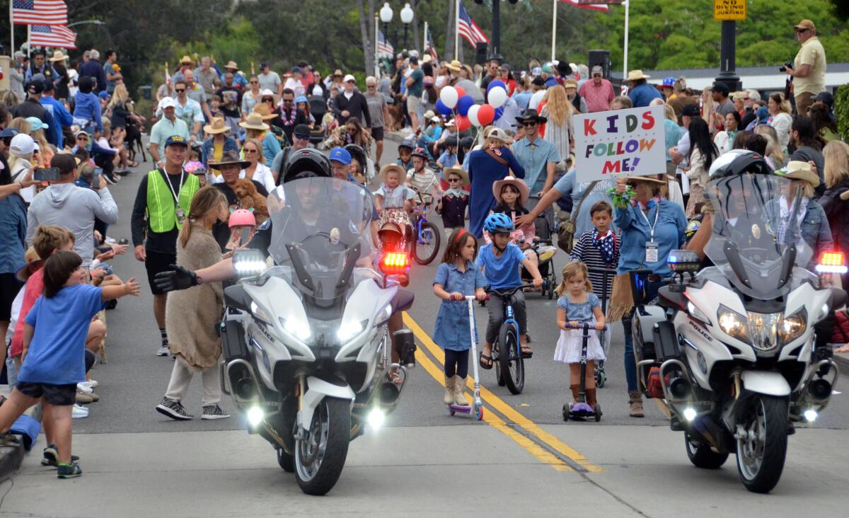 A Newport Beach motor officer with Kids of the Island leads parade.
