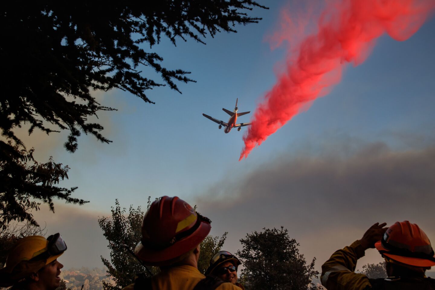 Firefighters watch as air tankers drop fire retardant ahead of the River fire in Lakeport, Calif., on Aug. 1.