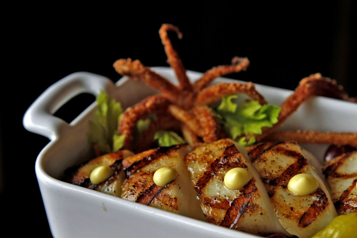 White Oak grilled sword squid with marinated gigande beans and lemon curd from Manhattan Beach Post. (Arkasha Stevenson / Los Angeles Times)