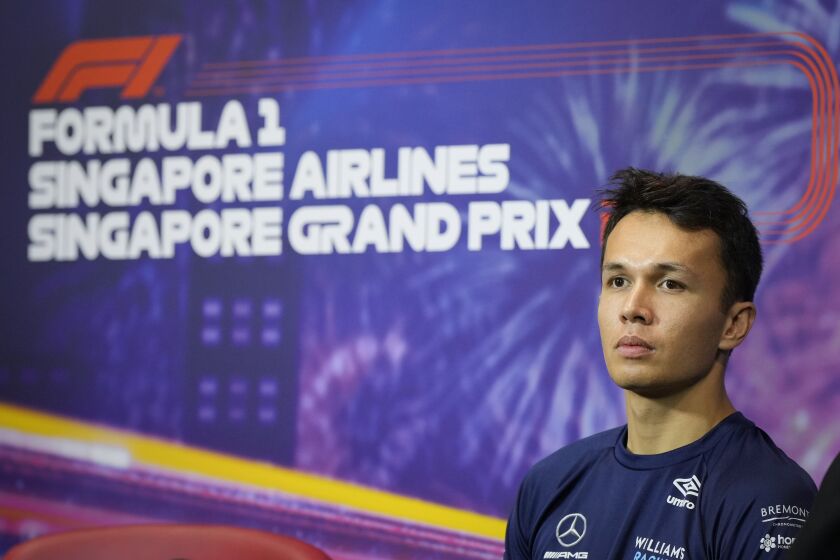 Williams driver Alexander Albon of Thailand listen to question during drivers press conference at the Marina Bay City Circuit ahead of the Singapore Formula One Grand Prix in Singapore, Thursday, Sept. 29, 2022. (AP Photo/Vincent Thian)