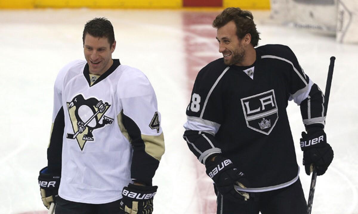 Kings center Jarret Stoll, right, and former Kings teammate Rob Scuderi of the Pittsburgh Penguins share a laugh before a game in January. The Kings have had a good deal of success against Eastern Conference opponents this season.