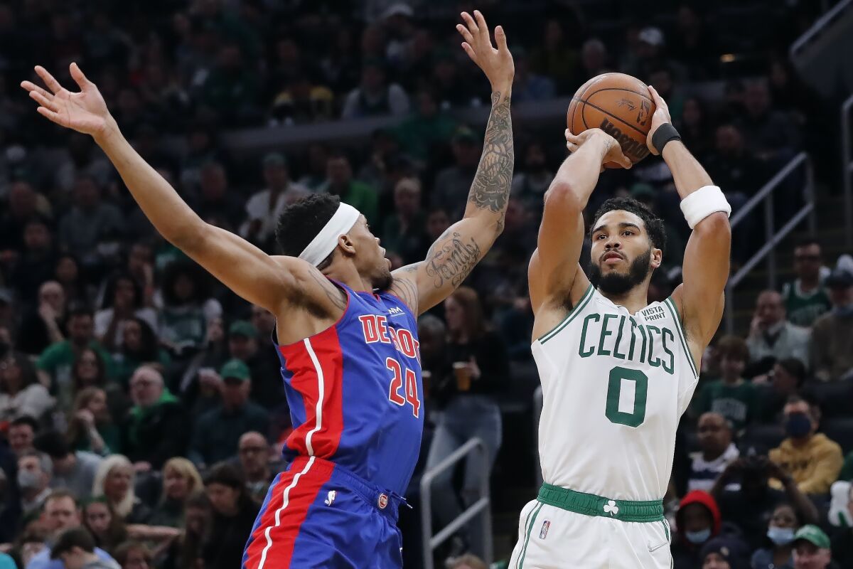 Boston Celtics' Jayson Tatum (0) shoots against Detroit Pistons' Jamorko Pickett (24) during the first half of an NBA basketball game Friday, March 11, 2022, in Boston. (AP Photo/Michael Dwyer)