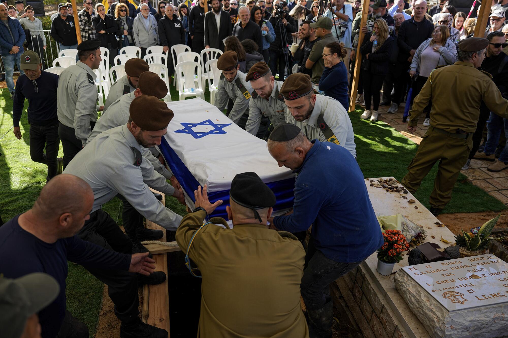 Israeli soldiers carrying flag-draped casket of fallen comrade