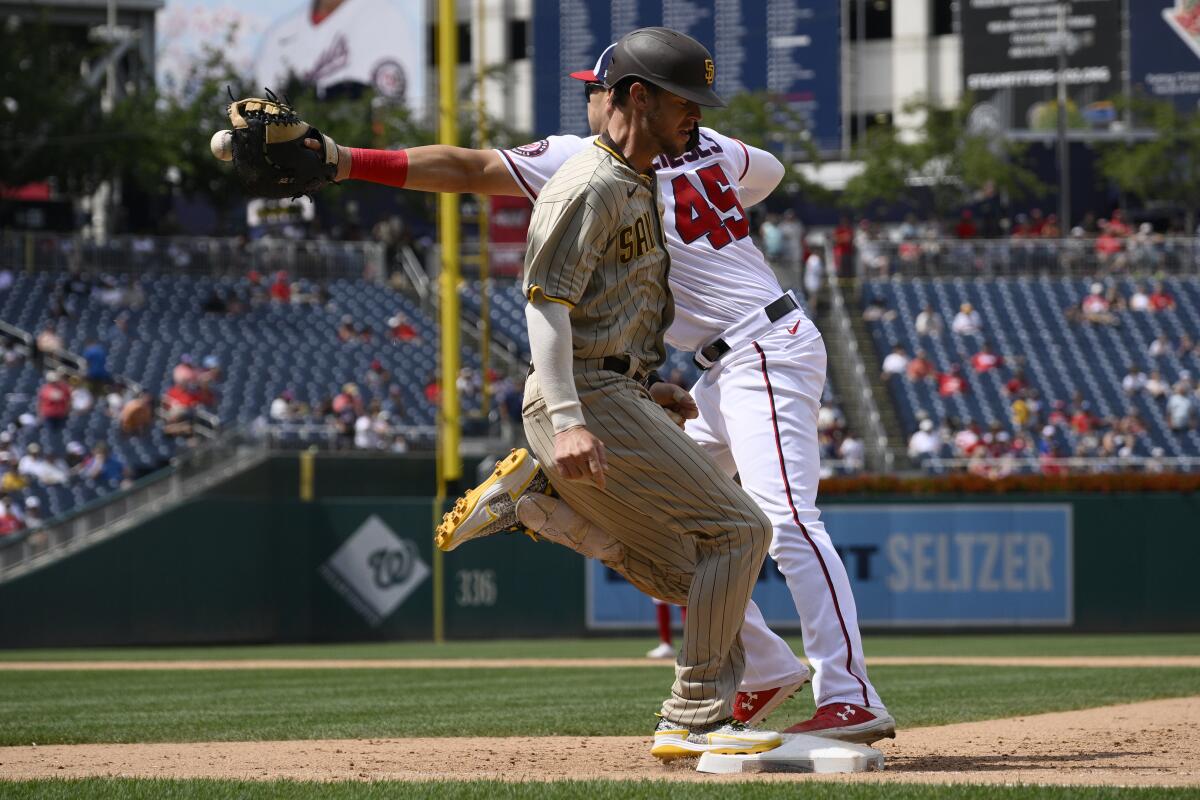 The Padres' Wil Myers beats out a single as Washington Nationals first baseman Joey Meneses waits for throw.
