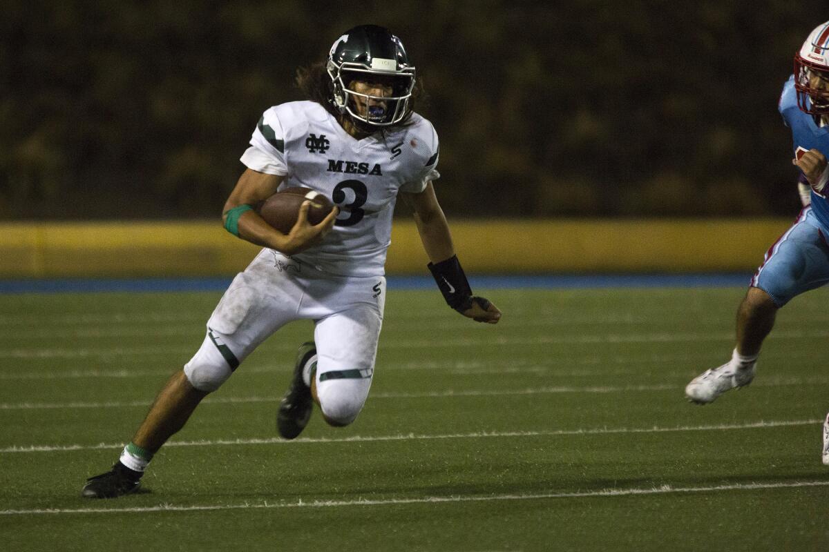 Costa Mesa's Nick Burton, shown running the ball against Santa Ana on Oct. 3, helped the Mustangs beat Saddleback 35-14 on Friday, earning their first Orange Coast League win since Nov. 4, 2016.